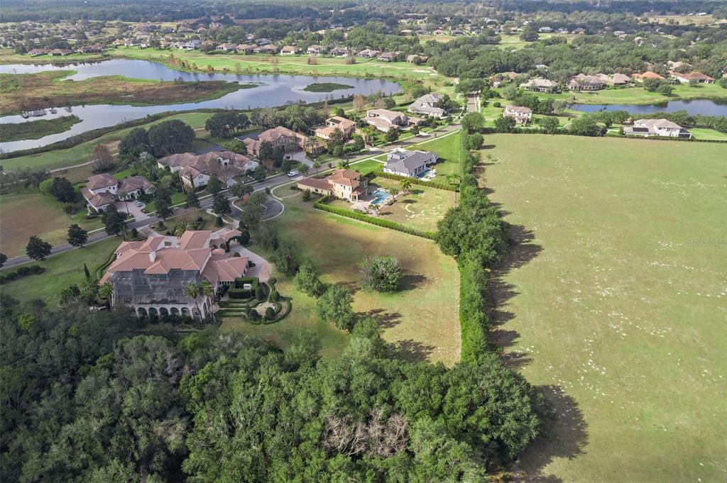 26027 Estates Ridge Drive Sorrento, FL 32776 - Photo 2 of 20 an aerial view of residential houses with outdoor space and lake view