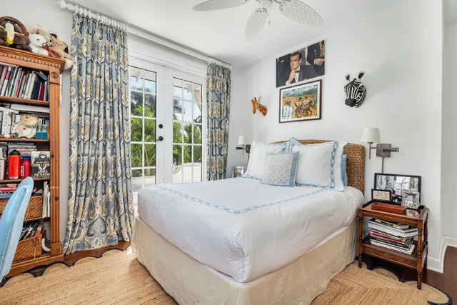 a bedroom with a bed and a book shelf