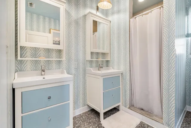 a bathroom with a sink a mirror and a shower