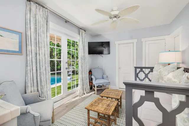a living room with furniture a flat screen tv and a large window