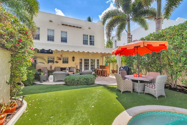 a view of a house with backyard sitting area and garden