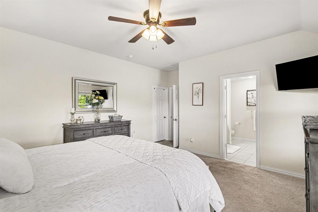 1237 Rushmore Drive Burleson, TX 76028 - Photo 12 of 28 a bedroom with a bed and a flat screen tv