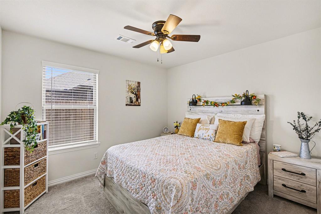 1237 Rushmore Drive Burleson, TX 76028 - Photo 15 of 28 a bedroom with a bed and ceiling fan