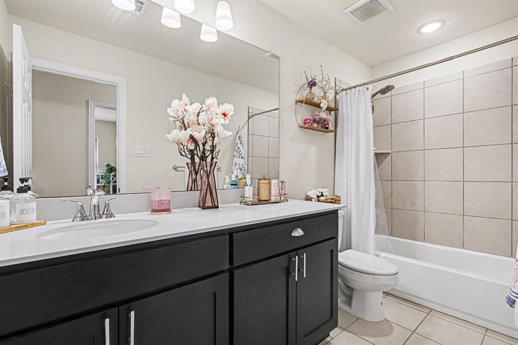 1237 Rushmore Drive Burleson, TX 76028 - Photo 17 of 28 a bathroom with a double vanity sink mirror and toilet