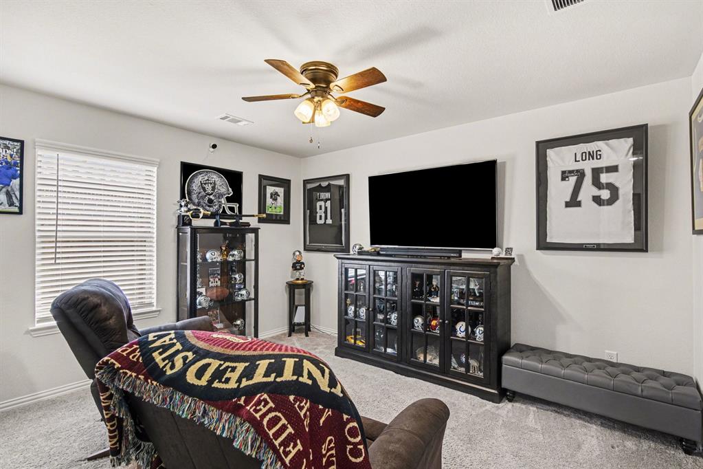 1237 Rushmore Drive Burleson, TX 76028 - Photo 19 of 28 a bedroom with furniture and a flat screen tv