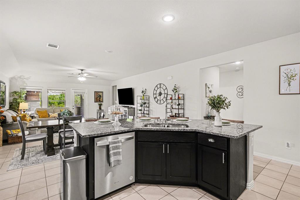 1237 Rushmore Drive Burleson, TX 76028 - Photo 7 of 28 a kitchen with a sink and cabinets
