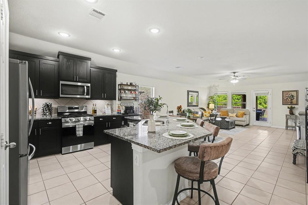 1237 Rushmore Drive Burleson, TX 76028 - Photo 8 of 28 a kitchen with sink refrigerator and cabinets