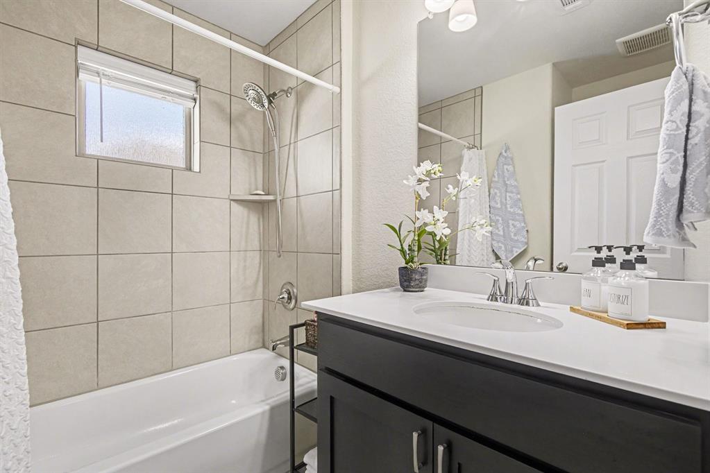 1237 Rushmore Drive Burleson, TX 76028 - Photo 9 of 28 a bathroom with a sink and a mirror