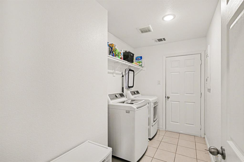 1237 Rushmore Drive Burleson, TX 76028 - Photo 10 of 28 a utility room with cabinets washer and dryer