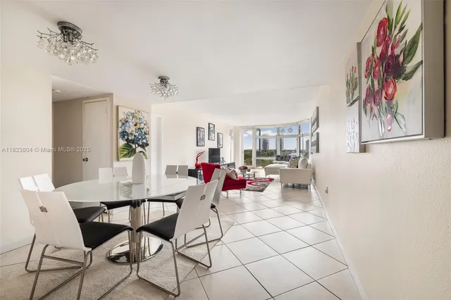 a view of a dining room with furniture and a chandelier