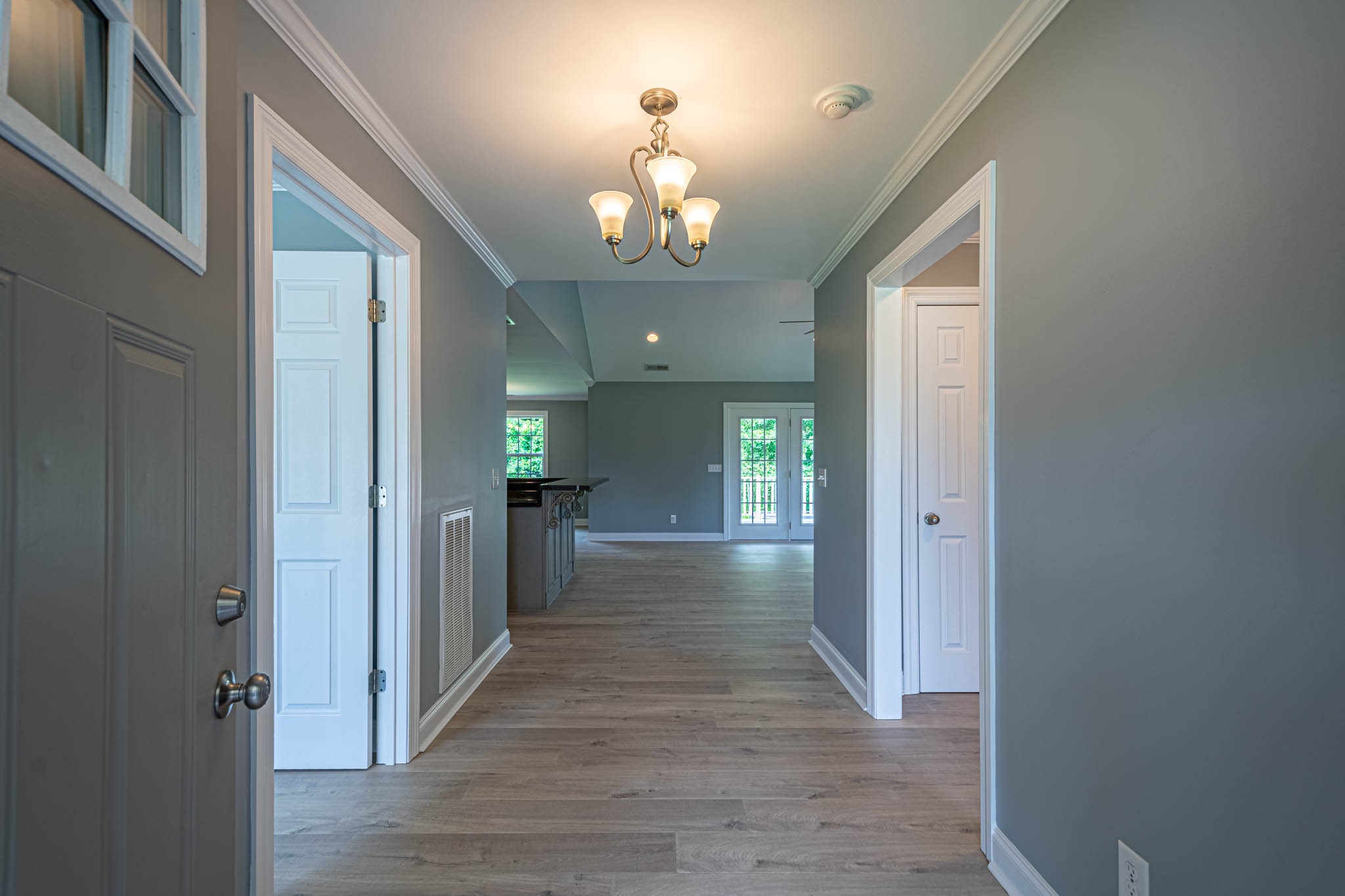 901 Cedar Pl Road Pulaski, TN 38478 - Photo 3 of 59 a view of a hallway with wooden floor and a chandelier