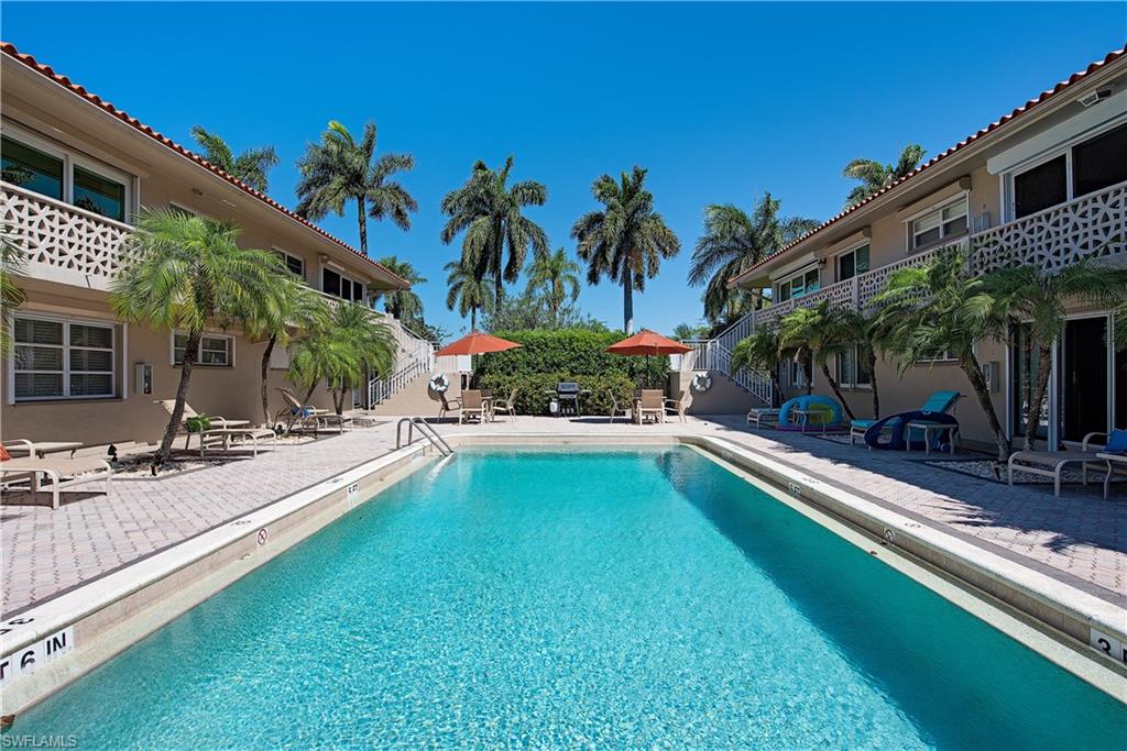 320 14th Avenue South, Unit 320D Naples, FL 34102 - Photo 2 of 3 a swimming pool with outdoor seating and yard