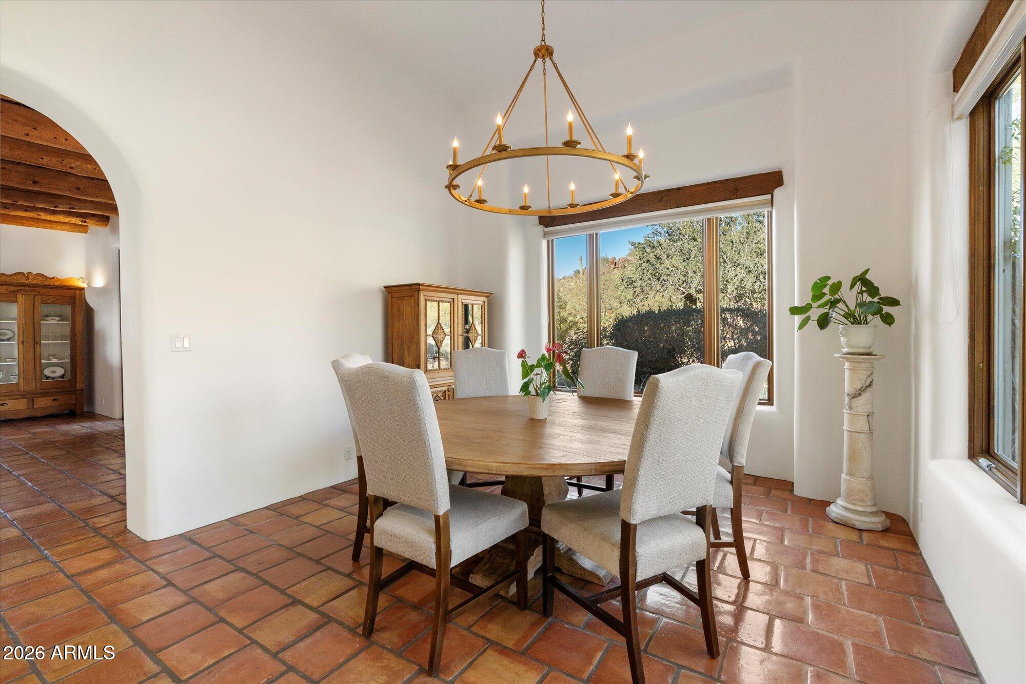 34815 North Arroyo Road Carefree, AZ 85377 - Photo 14 of 60 a dining room with furniture a chandelier and wooden floor