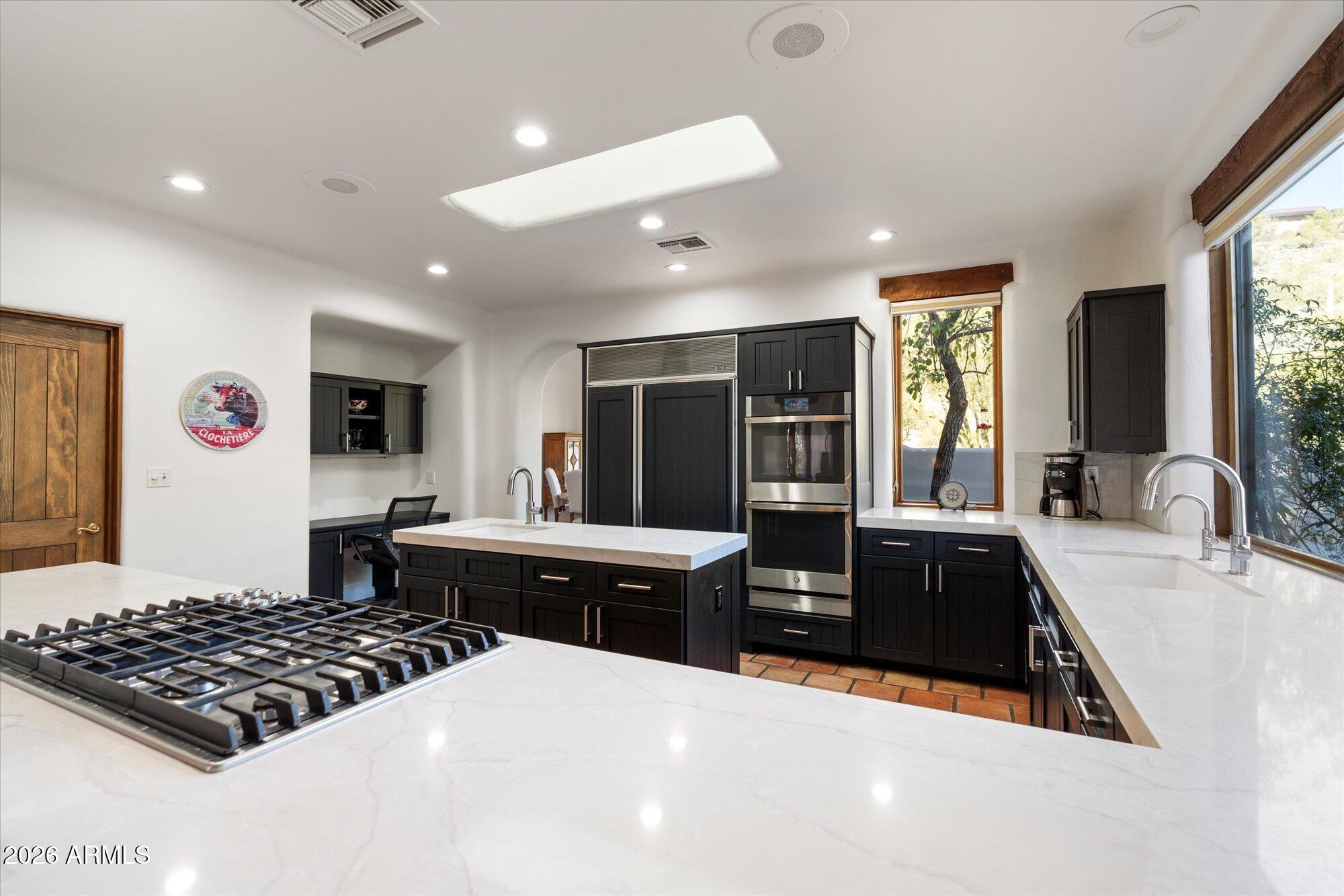 34815 North Arroyo Road Carefree, AZ 85377 - Photo 18 of 60 a large kitchen with stainless steel appliances granite countertop a sink stove and refrigerator