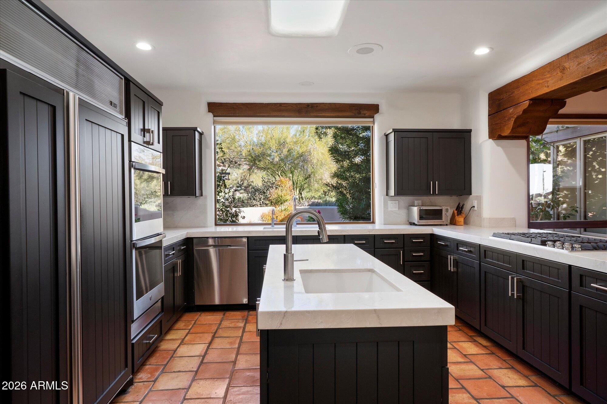 34815 North Arroyo Road Carefree, AZ 85377 - Photo 19 of 60 a kitchen with a sink stove and refrigerator