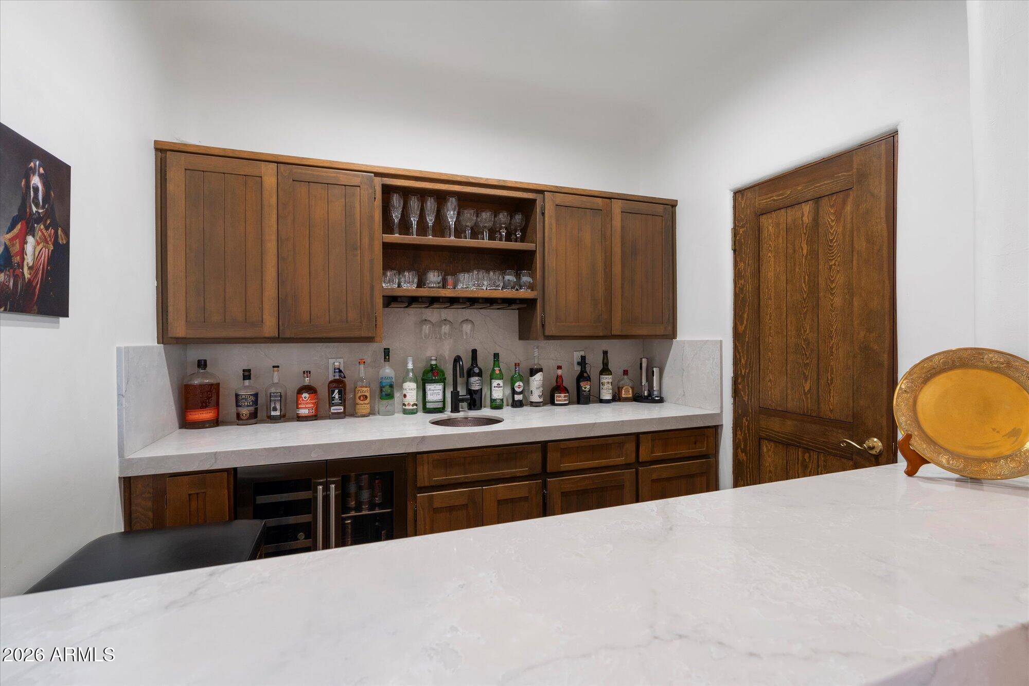 34815 North Arroyo Road Carefree, AZ 85377 - Photo 24 of 60 a kitchen with stainless steel appliances a sink stove and cabinets