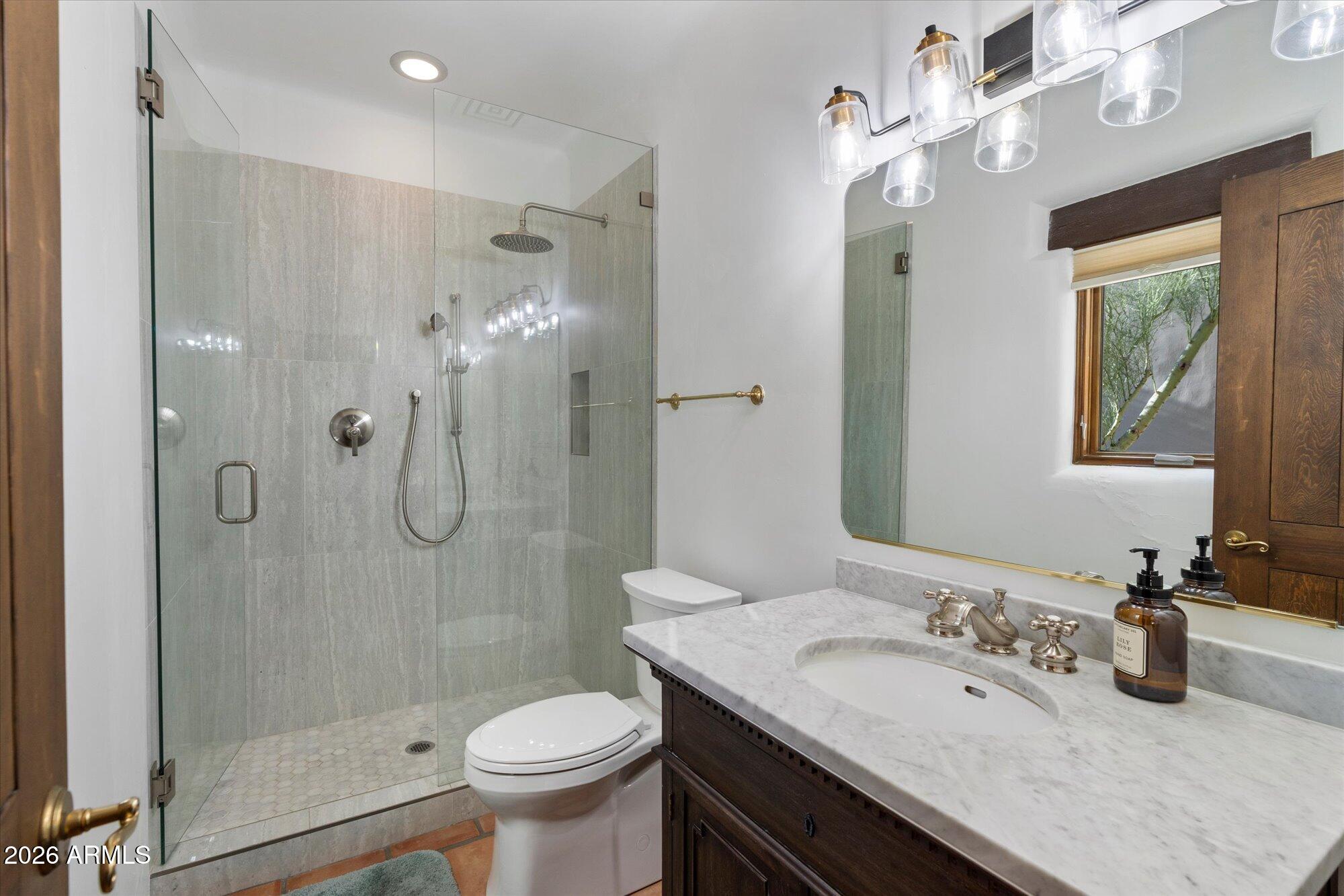 34815 North Arroyo Road Carefree, AZ 85377 - Photo 40 of 60 a bathroom with a sink a toilet and shower