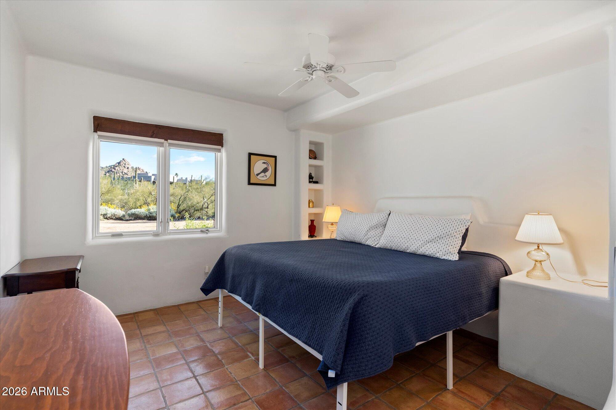 34815 North Arroyo Road Carefree, AZ 85377 - Photo 43 of 60 a bedroom with a bed and a window