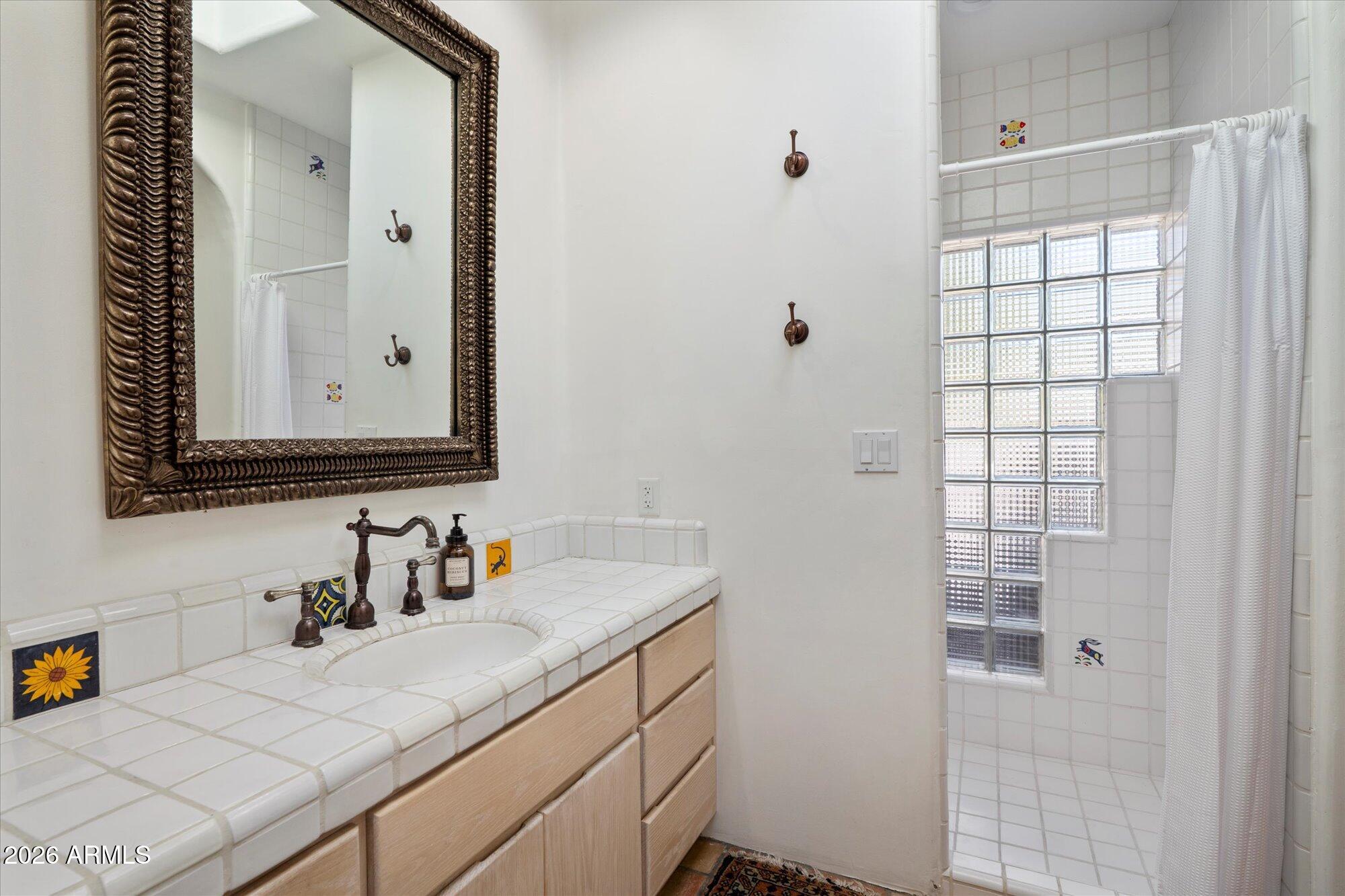 34815 North Arroyo Road Carefree, AZ 85377 - Photo 44 of 60 a bathroom with a sink and a mirror