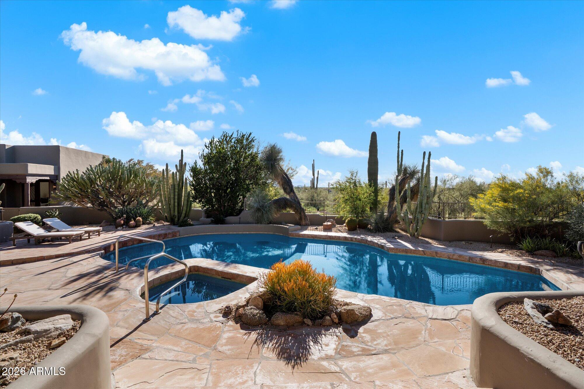 34815 North Arroyo Road Carefree, AZ 85377 - Photo 48 of 60 a view of a swimming pool and lounge chair