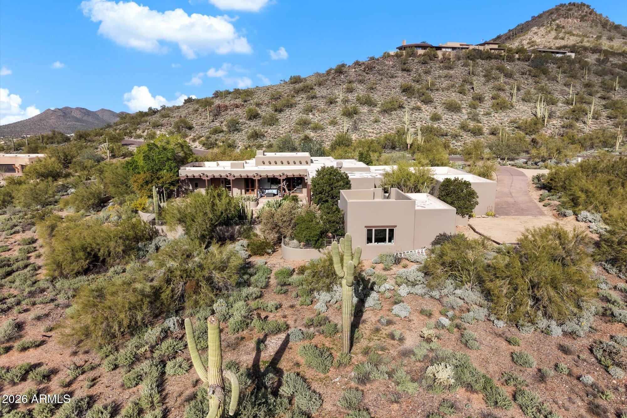 34815 North Arroyo Road Carefree, AZ 85377 - Photo 57 of 60 a view of a large building with a mountain in the background