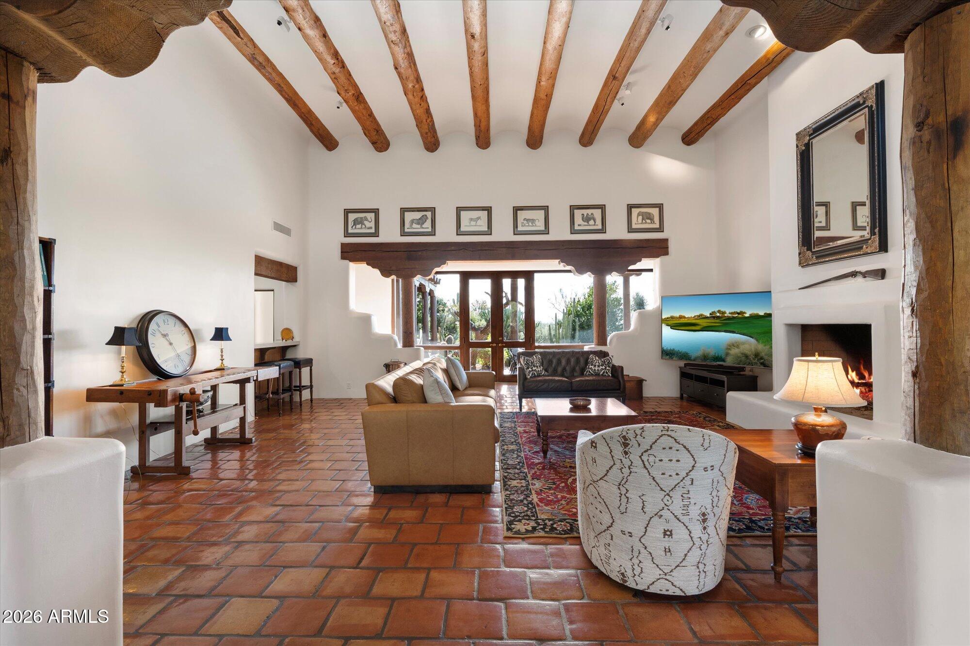 34815 North Arroyo Road Carefree, AZ 85377 - Photo 7 of 60 a living room with fireplace furniture and a large window