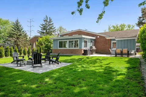 a house view with a garden space and patio