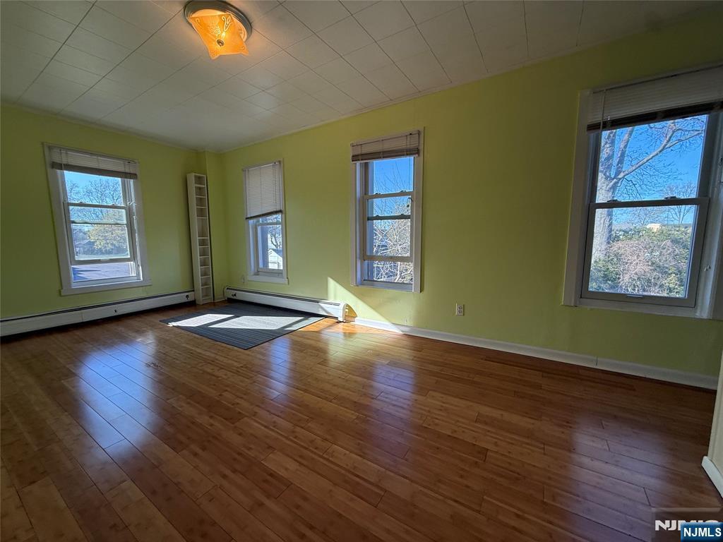 88 Main Street Little Ferry, NJ 07643 - Photo 18 of 32 a view of empty room with wooden floor and fan