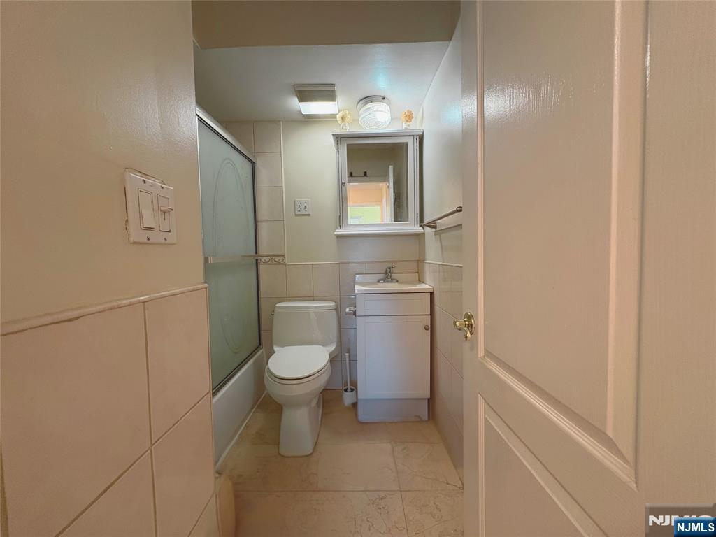 88 Main Street Little Ferry, NJ 07643 - Photo 20 of 32 a bathroom with a toilet sink and vanity