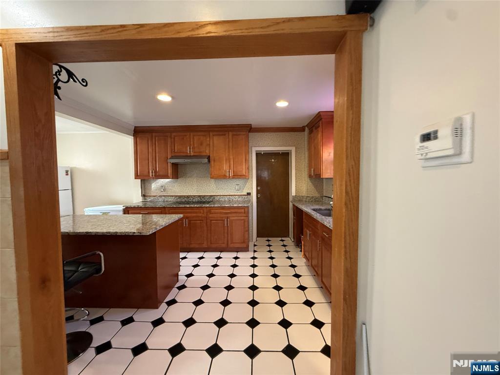 88 Main Street Little Ferry, NJ 07643 - Photo 10 of 32 a kitchen with a sink a refrigerator and cabinets