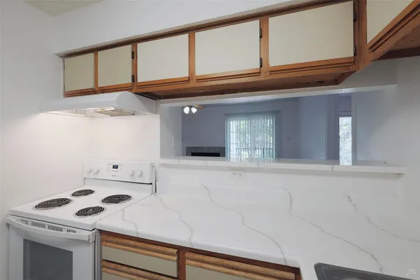 a white refrigerator freezer and a stove sitting inside of a kitchen