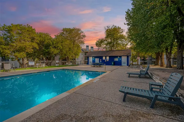 a view of a house with pool and sitting area