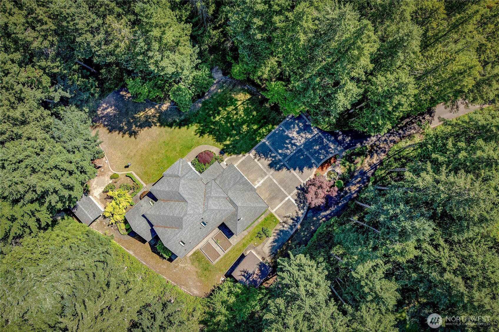 4354 Northwest Westgate Road Silverdale, WA 98383 - Photo 37 of 40 an aerial view of a house with a yard and trees