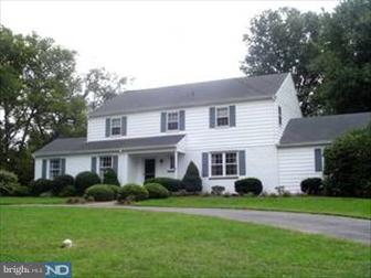 a front view of a house with a garden and porch