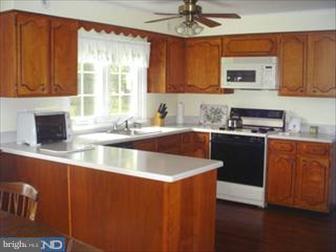 1222 Upper Gulph Road Wayne, PA 19087 - Photo 4 of 6 a kitchen with stainless steel appliances granite countertop a sink a stove and a microwave