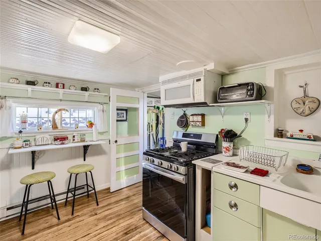 a kitchen with stainless steel appliances a stove a sink and cabinets