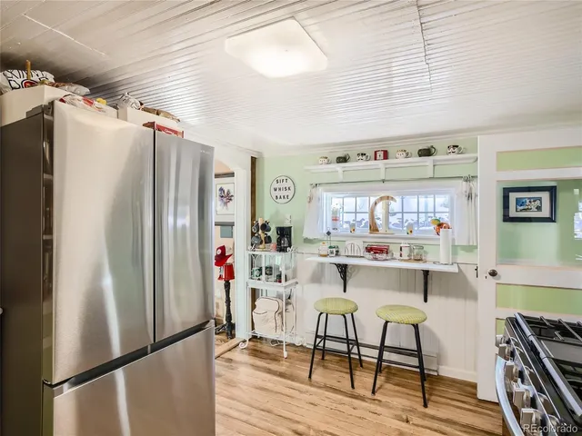 a kitchen with stainless steel appliances a refrigerator a sink and a stove