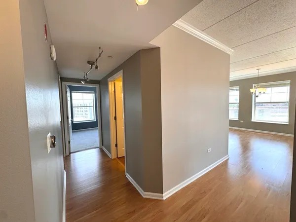 a view of hallway with wooden floor