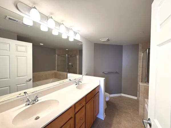 a bathroom with a sink double vanity and a mirror