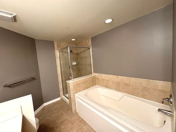 a bathroom with a bathtub and shower