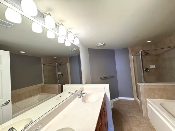 a bathroom with a bathtub a sink and a shower