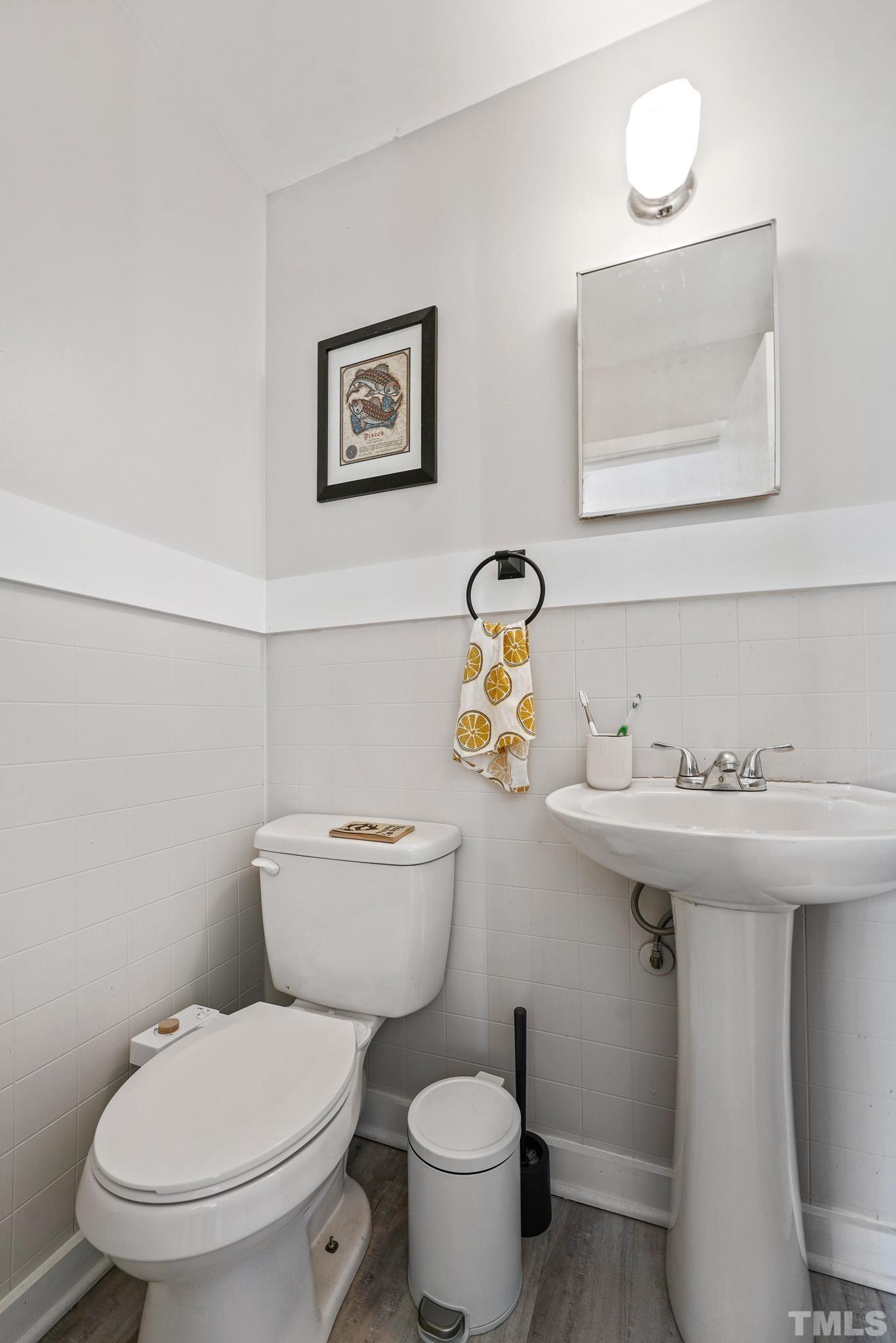 625 Coleman Street Raleigh, NC 27610 - Photo 17 of 22 a bathroom with a toilet sink and mirror