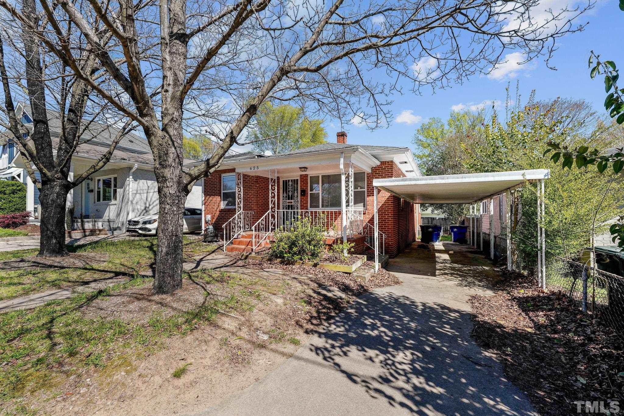625 Coleman Street Raleigh, NC 27610 - Photo 3 of 22 a view of a house with a yard patio and fire pit