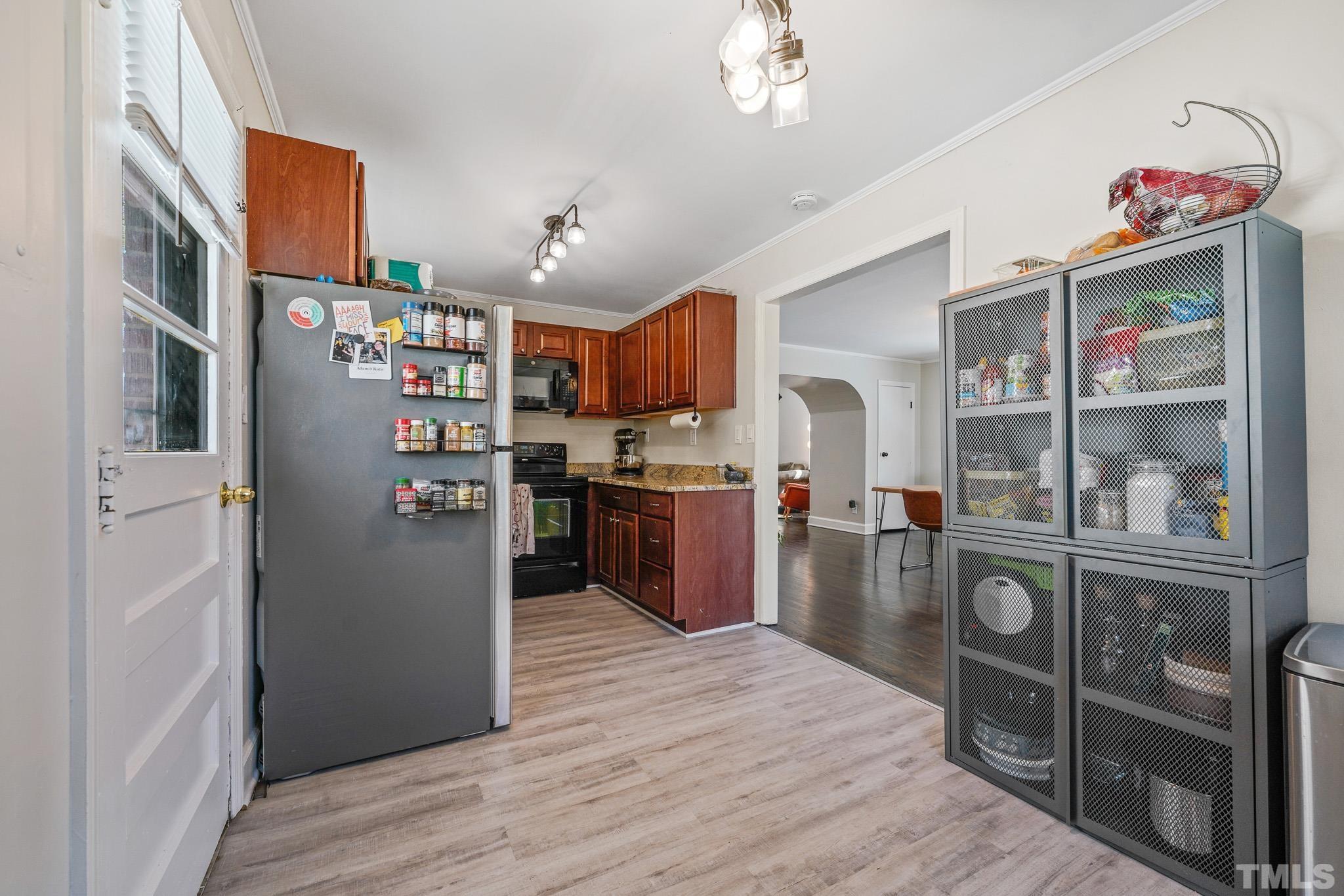 625 Coleman Street Raleigh, NC 27610 - Photo 10 of 22 a kitchen with stainless steel appliances granite countertop a refrigerator a stove and a wooden floors
