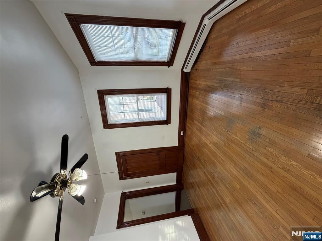 64 Knickerbocker Road, Unit 2 2 Englewood, NJ 07631 - Photo 11 of 27 a view of an empty room with wooden floor and a window