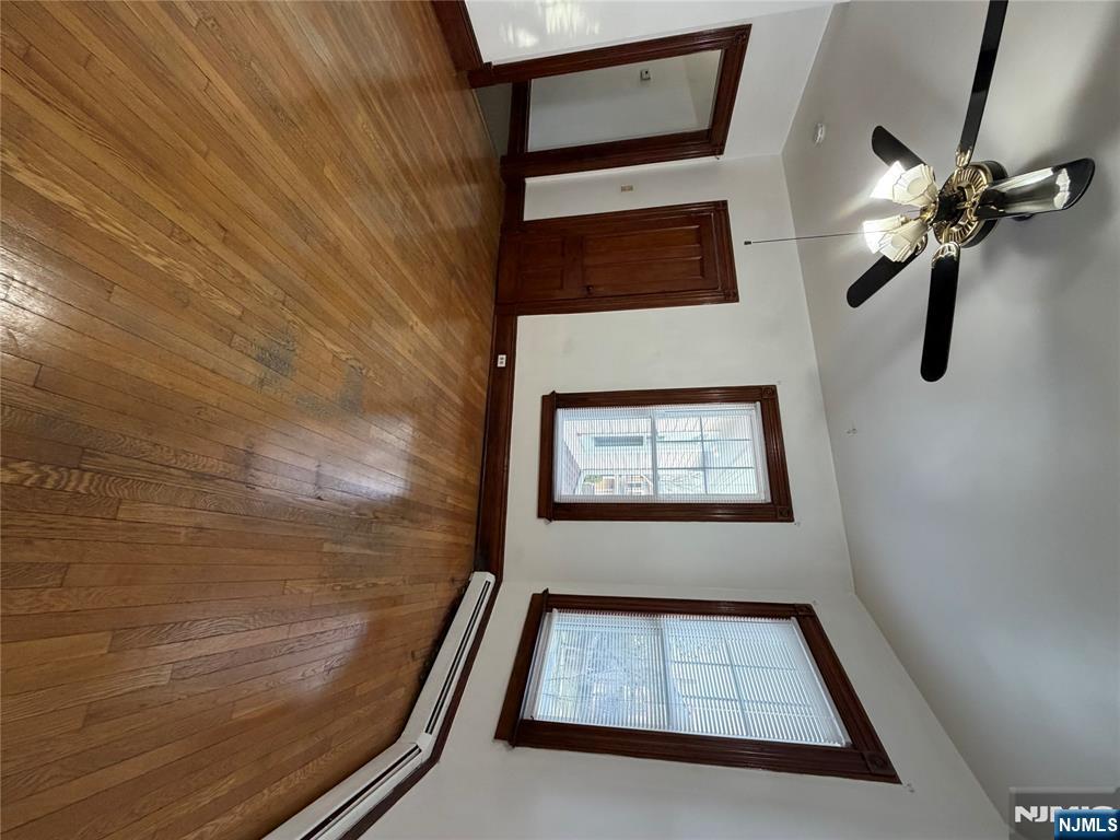 64 Knickerbocker Road, Unit 2 2 Englewood, NJ 07631 - Photo 12 of 27 a view of an empty room with wooden floor and a window