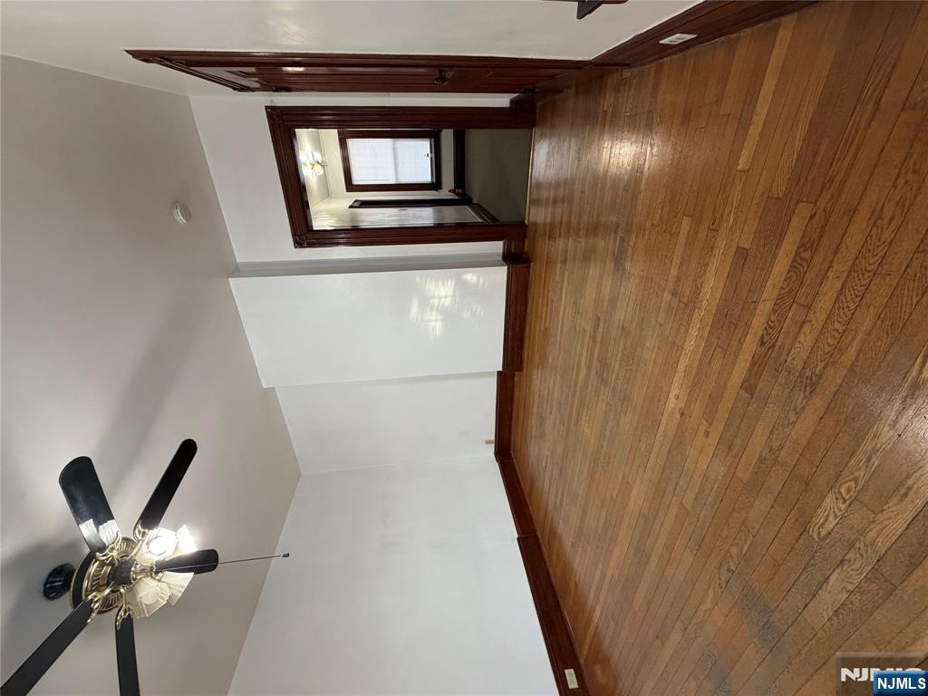 64 Knickerbocker Road, Unit 2 2 Englewood, NJ 07631 - Photo 14 of 27 an empty room with wooden floor chandelier fan and windows