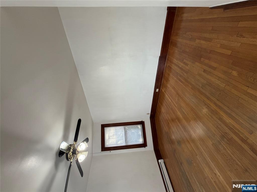 64 Knickerbocker Road, Unit 2 2 Englewood, NJ 07631 - Photo 15 of 27 an empty room with wooden floor chandelier fan and windows