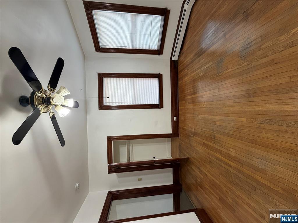 64 Knickerbocker Road, Unit 2 2 Englewood, NJ 07631 - Photo 17 of 27 a view of an empty room with wooden floor and a window