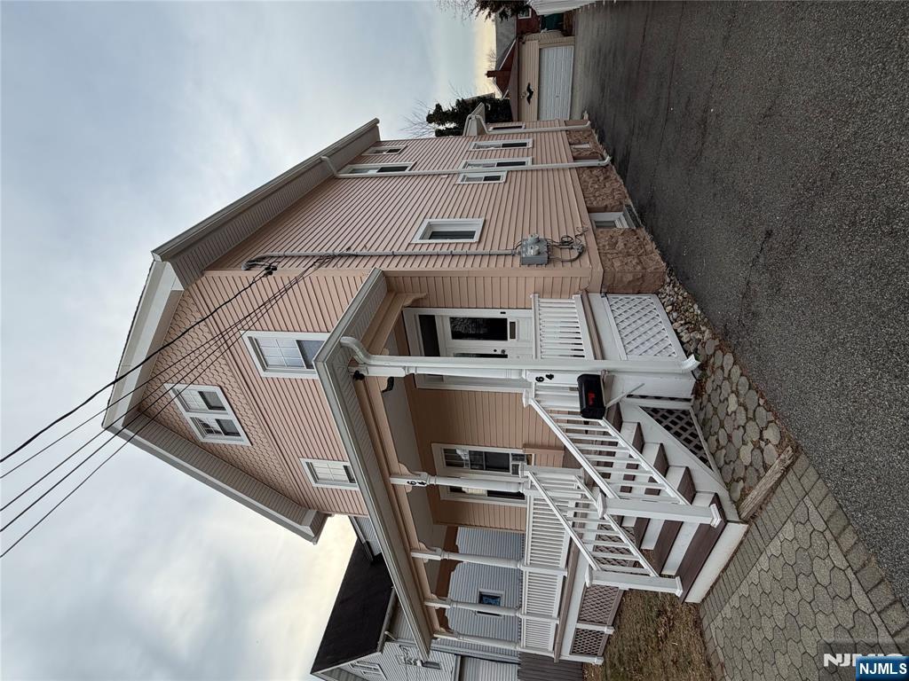 64 Knickerbocker Road, Unit 2 2 Englewood, NJ 07631 - Photo 2 of 27 a white house with a large window and wooden fence